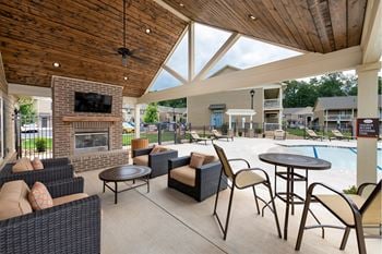 Outdoor pavilion with fireplace, flat screen tv, and food area